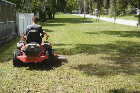 Ton's Ag mowing a large lawn in Brooksville