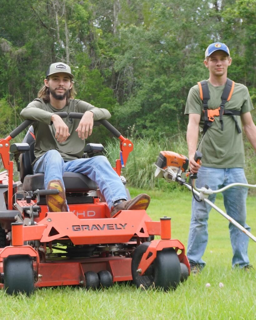 Crew members from Tons Agricultural Services standing on a finished property.